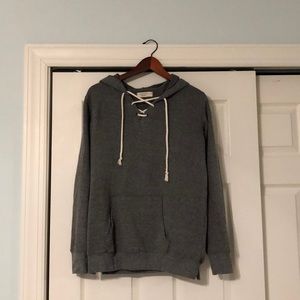 gray sweatshirt with crisscross rope like tie